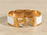 a close up of a gold and white ring on a wooden surface