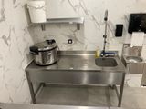 a kitchen with a sink and a pot on the counter