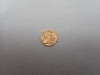 gros plan d'une pièce d'or sur une surface blanche