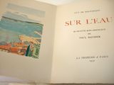 an open book with a picture of a city on it