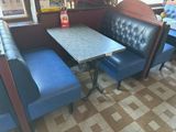 a booth with a table and two chairs in it