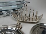 a silver plate and a silver plate holder on a table