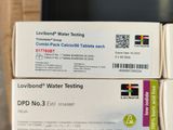 two boxes of water testing equipment sitting on top of a box