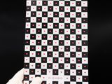 someone is holding up a checkerboard with hearts on it