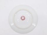 a white plate with a red and white design on it
