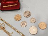 a lot of gold and silver coins on the table
