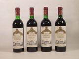 trois bouteilles de vin sont alignées sur une surface blanche