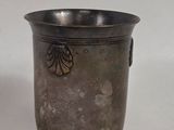 a silver cup that is sitting on a table