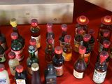 many bottles of alcohol lined up on a red table
