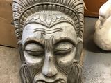a statue of a man wearing a headdress on the ground