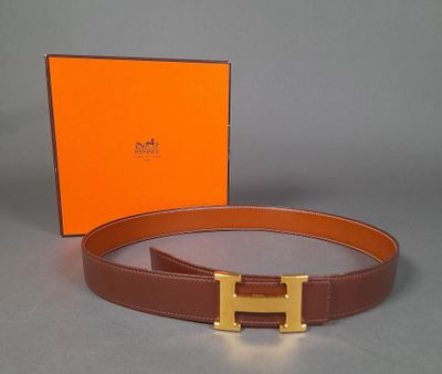 the belt is brown and has a gold buckle on it