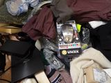 a pile of clothes and other items on the floor