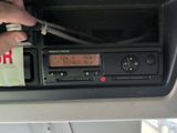 a hand that is holding a radio in a car