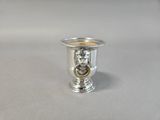 a silver cup with a lion head on it