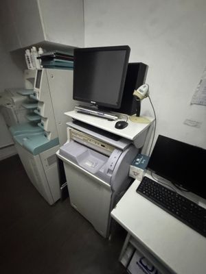 a desk with a computer and a printer on it