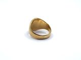 a close up of a gold ring on a white surface