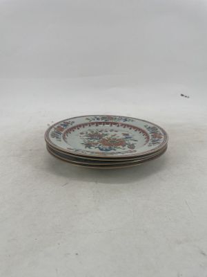 three plates that are sitting on a white surface