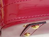 a pink purse that is sitting on a white surface
