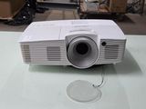 a white projector sitting on top of a glass table