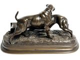 bronze statue of a dog and a cat on a wooden base