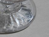 a glass of water sitting on a table next to a spoon