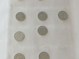 a lot of coins in a plastic bag on a table