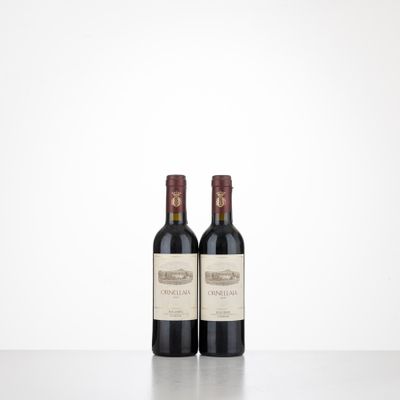 two bottles of wine sitting on top of a table next to each other