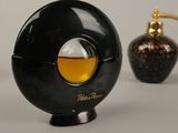 a bottle of perfume next to a coffee grinder