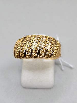 a close up of a gold ring on a white surface