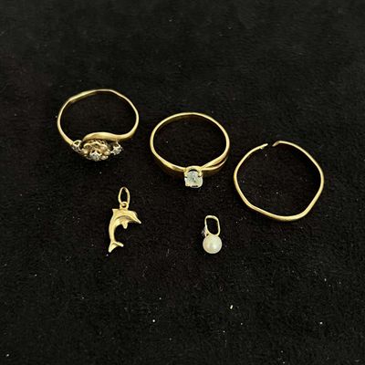 three gold rings and a ring with a dolphin on it