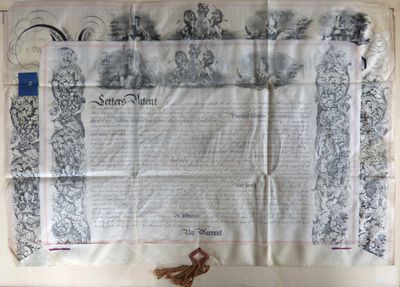an old document with a tassel on top of it on a table