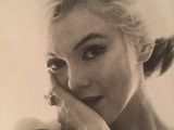 an old black and white photo of a woman with her hand on her face