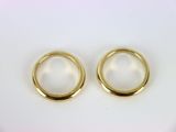 two gold wedding rings sitting on top of a white surface