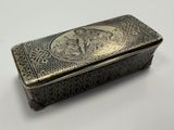 an old silver box with a picture of a man and a woman on it
