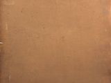 an old piece of brown paper sitting on top of a wooden table