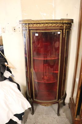 a small cabinet with a glass door in a room