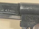 a close up of a gun that is on a wall