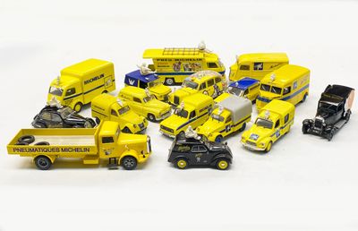 a lot of toy cars and trucks on a white surface