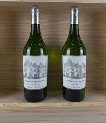 two bottles of wine sitting on top of a wooden shelf