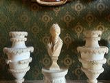 three vases that are sitting on a table in front of a mirror