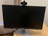 a computer monitor sitting on top of a wooden desk