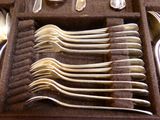 plusieurs cuillères et fourchettes dans un étui sur la table