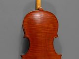 an old violin hanging on a wall in a room