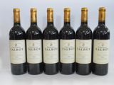 six bottles of red wine are lined up in a row