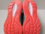 a close up of a pair of red shoes on a white surface