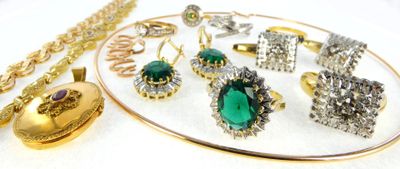 a white plate with a bunch of jewelry on it