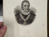 someone is holding a piece of paper with a drawing of a man in a dress