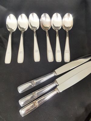 five spoons and a knife on a black cloth