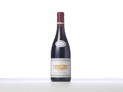 a bottle of red wine sitting on top of a table