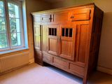 a large wooden cabinet in the corner of a room